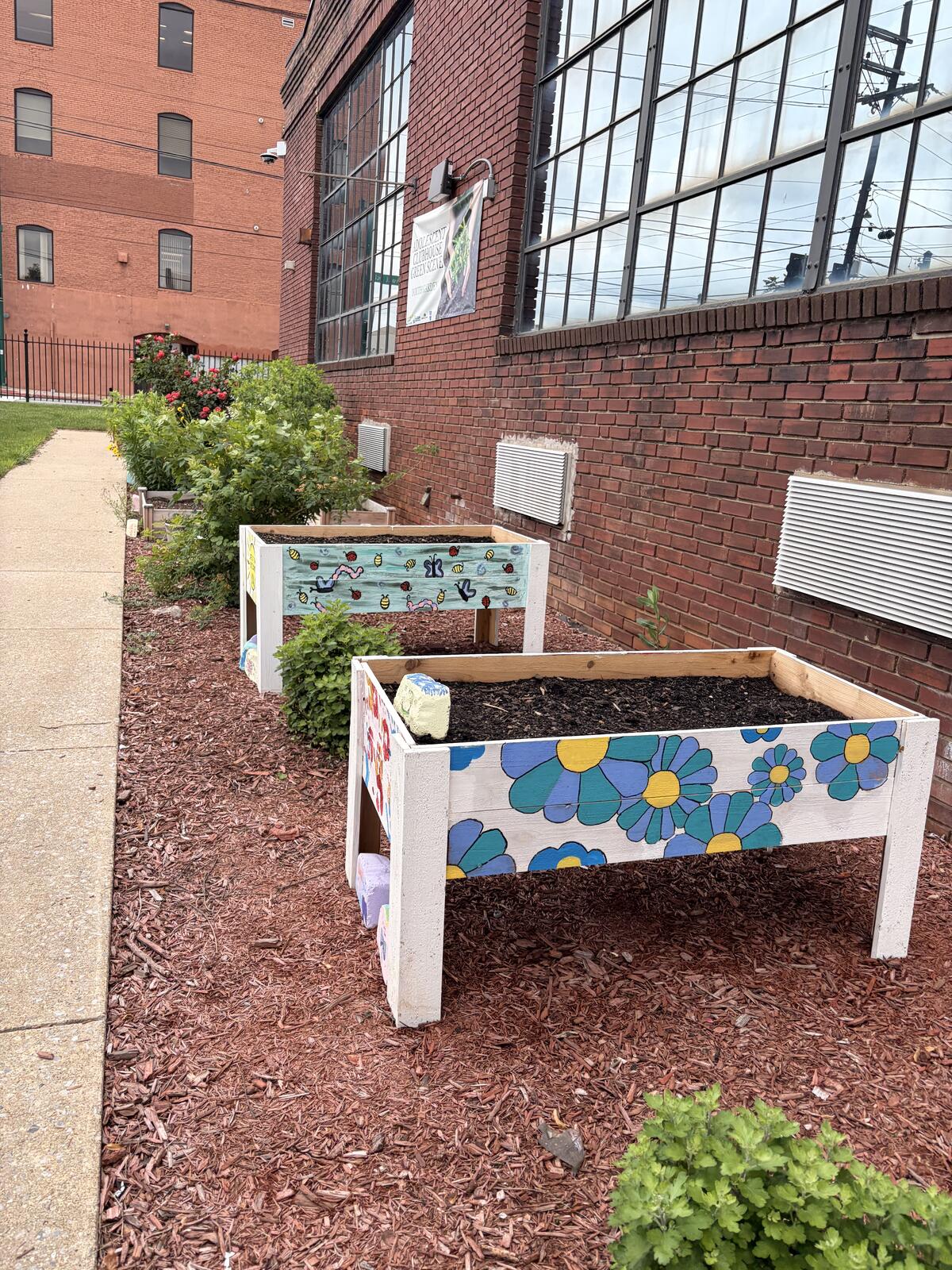 Hand-painted raised garden beds outside the Adolescent Clubhouse